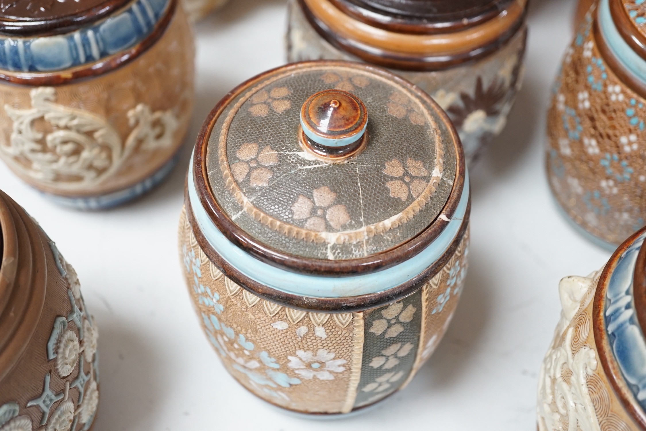 A quantity of Doulton stoneware tobacco jars and jugs